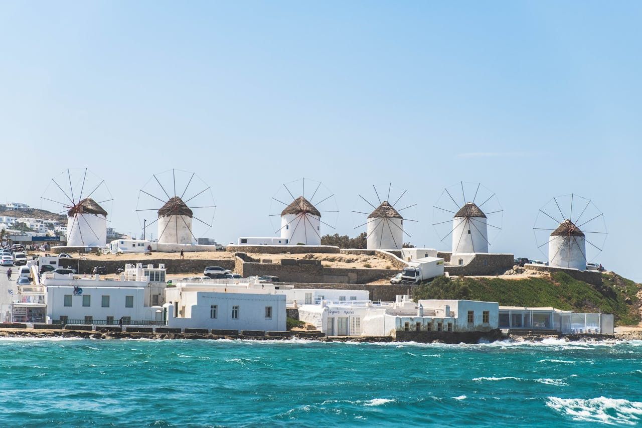 Mykonos waterfront, whitewashed buildings and historic windmills beside the sea